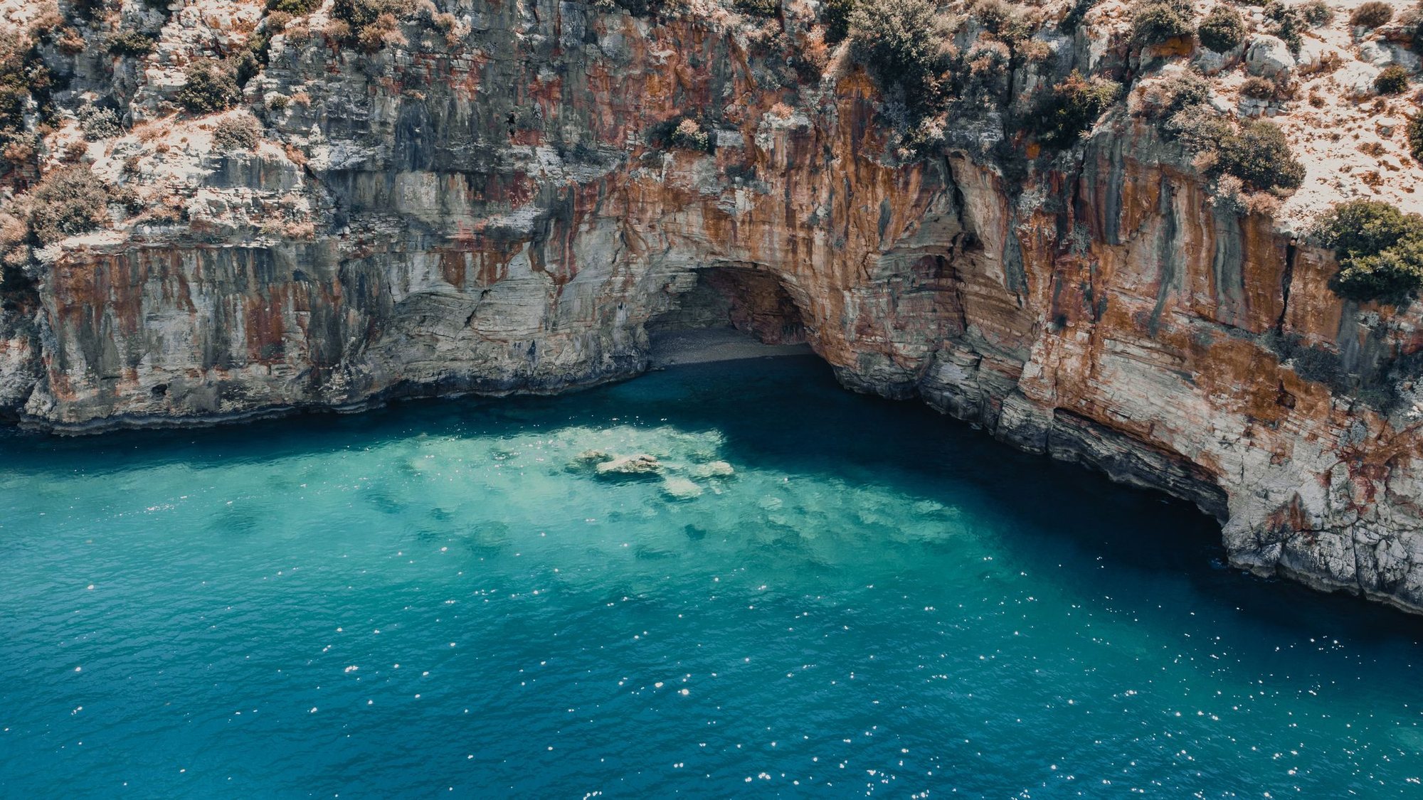 Turquoise cove and cliff cave in the Balearics